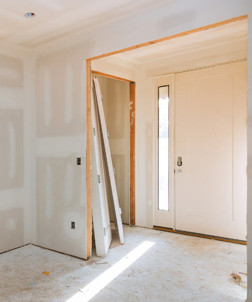 A room with a door and a ladder in it